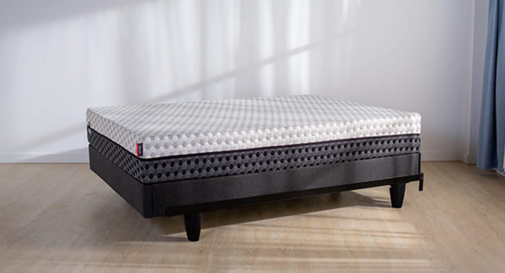 Side view of a Layla mattress on a simple bed frame in a bedroom.